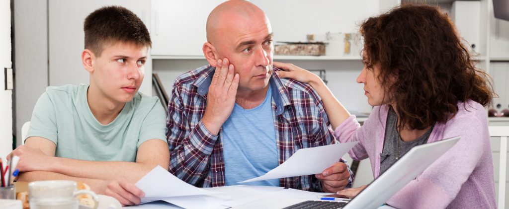 Wife with teenager comforting upset man